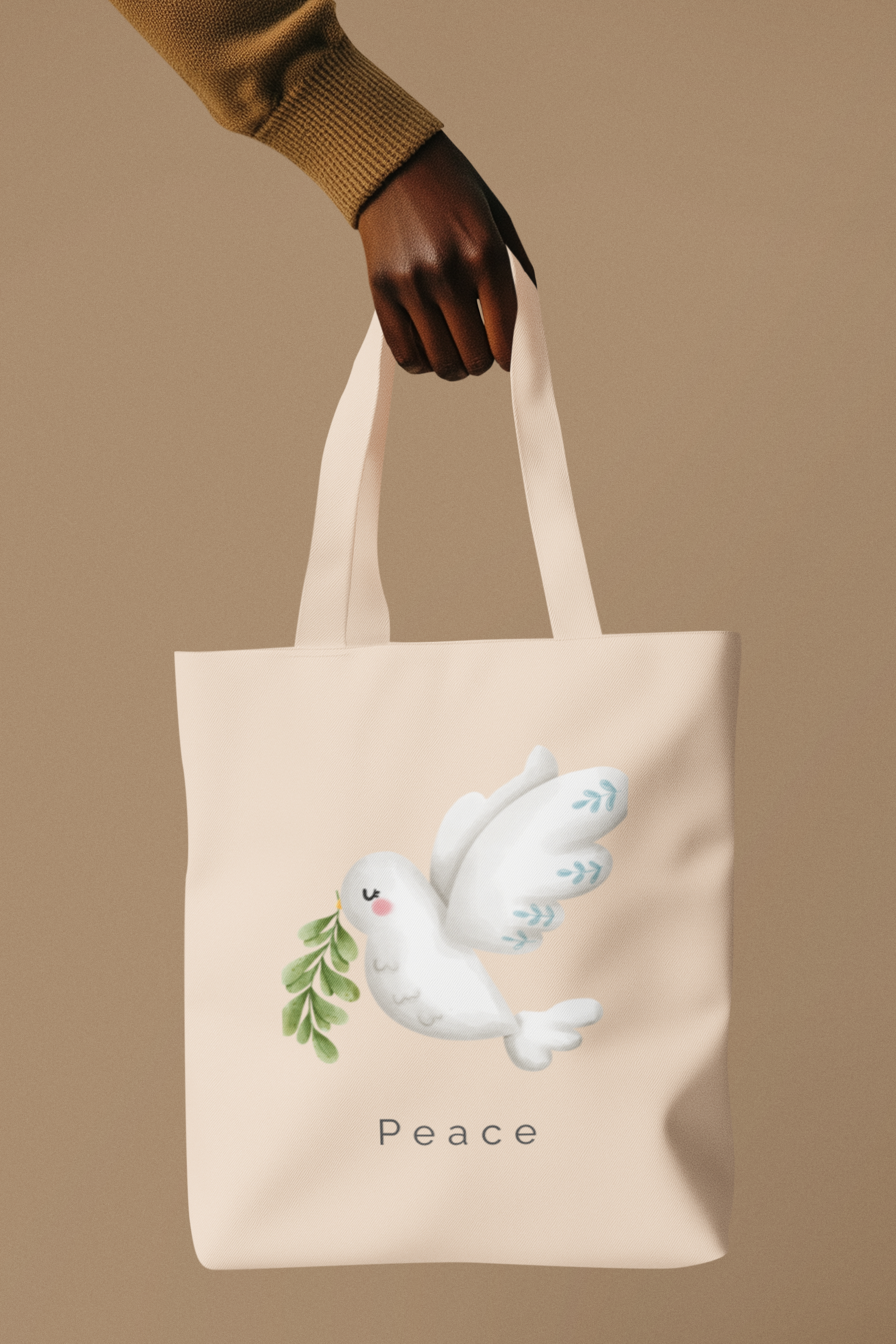 Cream-colored tote bag with a soft watercolor dove carrying olive leaves, above the word “Peace” in minimalist font.